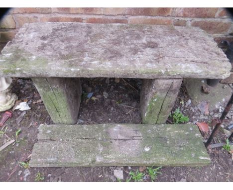 A concrete garden bench and a step depicting old wood 