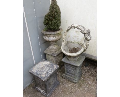 Three odd concrete pedestals and two planters to include a basket style planter 
