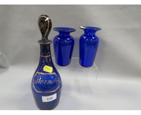 A small blue glass decanter and stopper "Brandy" together with two blue glass vase (3)