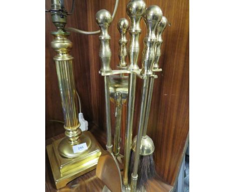 A Column effect brass type table lamp together with a companion set 