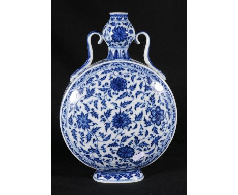 Chinese early 20th century blue and white moon flask with scroll handles, the body decorated with flowerheads and scrolling f