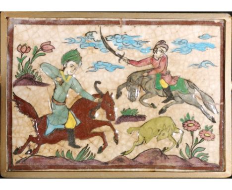 Persian glazed tile panel of rectangular shape decorated with two horsemen hunting a deer, 26cm x 37cm, within a metal frame.