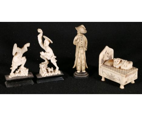 A Chinese bone carving of a bed with incised decoration, the sliding lid with two carved puppies, 6.5cm, two Chinese carved f