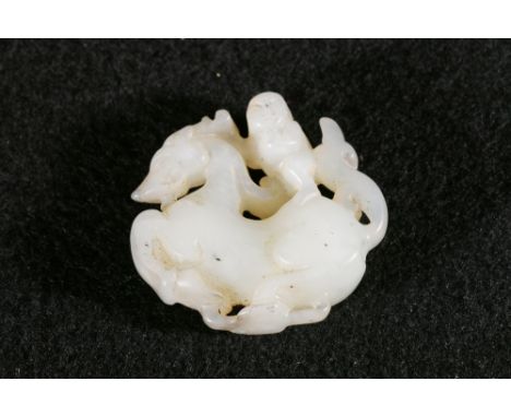 Late 19th century Chinese century jade carving or pendant riding on the back of a horse, traces of earlier paintwork or gildi