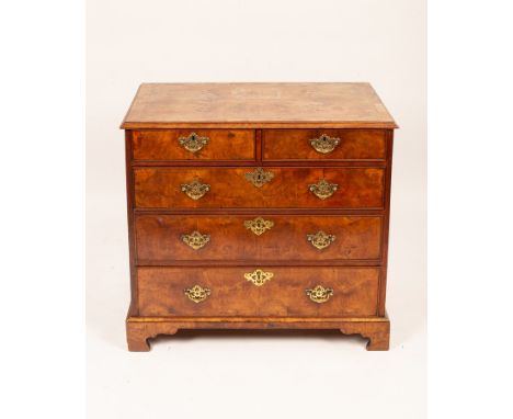 An 18th Century walnut and featherbanded chest of two short over three long drawers on later bracket feet, 94cm wide, 54cm de
