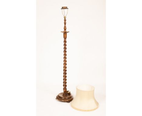 An oak standard lamp with a spiral carved column and dish turned base, surmounted by a silk and pleated silk shade CONDITION 