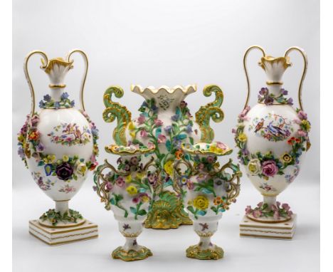 A pair of Continental porcelain vases, oviform with double-lipped neck, applied with a flower-encrusted garland to each side 