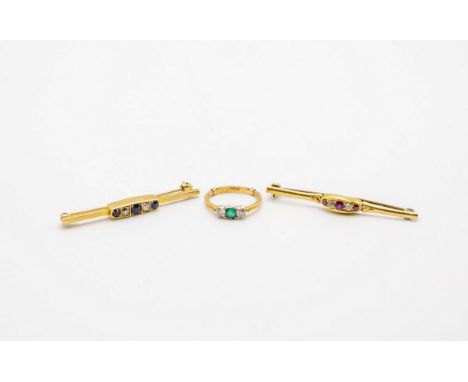 A sapphire and diamond bar brooch, set in 18ct yellow gold, a similar ruby and diamond bar brooch and an emerald and diamond 