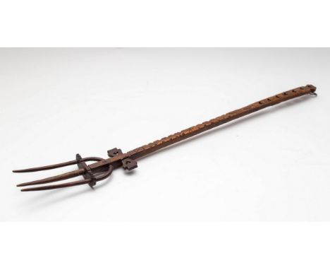 A treen toasting fork, possibly a Welsh love token, 60cm long CONDITION REPORT: Condition information is not usually provided