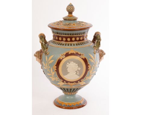 A Mettlach stoneware two-handled vase and cover in the majolica style, the globular body applied to each side with a cameo po