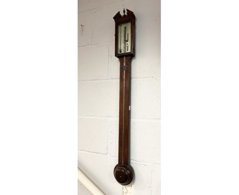 A George III stick barometer, the mahogany case with a broken architectural cornice and brass vase finial. Marked Donegan and