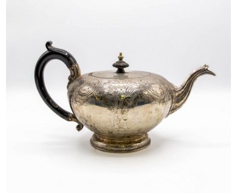 A George IV silver teapot, Robert Garrard, London 1823, with shell and scroll engraved decoration, fitted an ebonised handle,