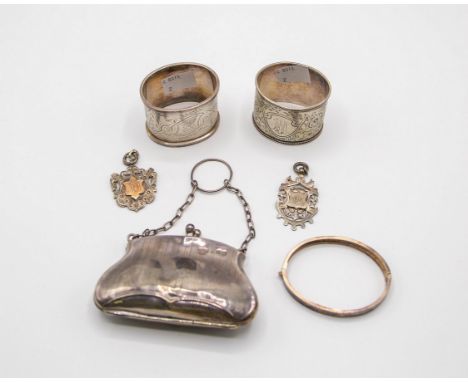 A silver purse, Birmingham 1918, two Russian silver napkin rings, a Christening bangle, Chester 1886 and two silver medallion