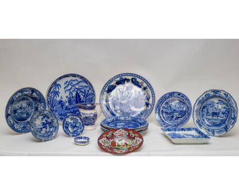 A collection of blue and white printed wares to include a Wedgwood Waterlily pattern charger, a cheese stand, a lozenge suppe