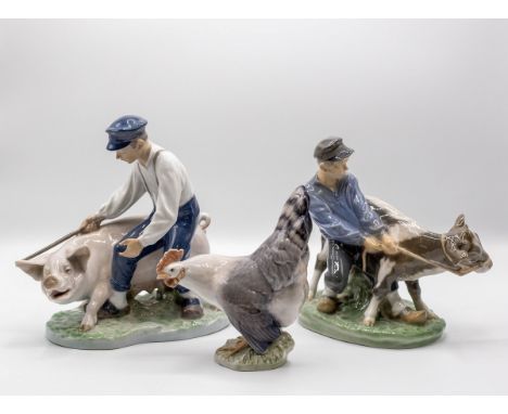 Two Royal Copenhagen figure groups of boys with a cow and a pig, and a model of a cockerel, 19.5cm high CONDITION REPORT: cow