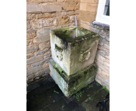 A stone planter on plinth with wreath carved sides, 94cm high x 51cm wide CONDITION REPORT: Condition information is not usua