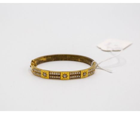 A Victorian gilt metal christening bangle, set with three old cut diamonds with two rows of pearls, approximately 13.2g gross