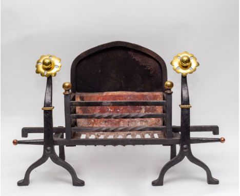 An iron fire grate, the front with two brass finials and a pair of fire dogs with stylised brass flowerhead terminals, size w