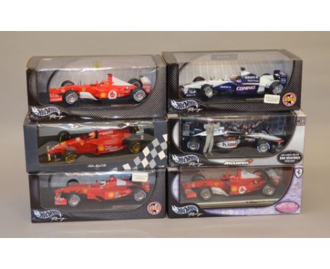 Five 1:18 scale Mattel Hot Wheels diecast model vehicles including: F2001; Sakhir / Bahrain; F2002; Williams F1 team FW23; Mc