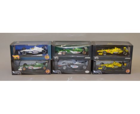 Six Hot Wheels Racing 1:18 scale diecast model vehicles including: McLaren MP4-16 Mika Hakkinen; Jaguar Racing R2 Eddie Irvin