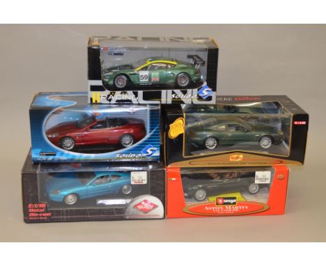 Five 1:18 diecast model vehicles including: Guiloy Aston Martin DB7; Maisto Aston Martin DB7 Vantage; Burago Aston Martin V12