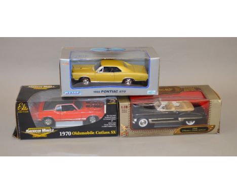 Three 1:18 scale diecast model vehicles including: Welly 1966 Pontiac GTO: Yat Ming 1949 Coupe Deville; ERTL Collectibles 197