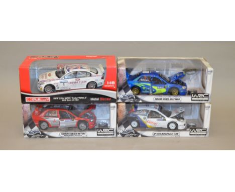 Four 1:18 scale diecast model vehicles including: 3x Hot Wheels Team Mitsubishi Motors/ Subaru World Rally Team/ BP Ford Worl