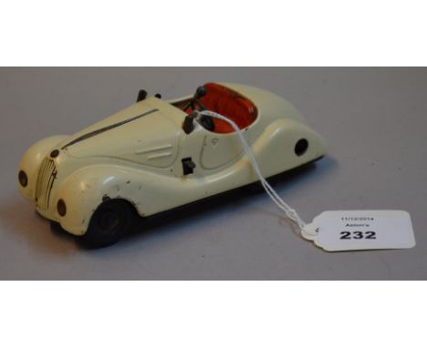 Schuco Examico 4001 tinplate clockwork car, cream with red seats, tinprinted dashboard, gear stick and steering wheel. Length