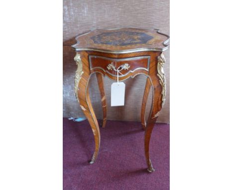 An early 20th century Louis XV style walnut lamp table, with marquetry inlay, having ormolu mounts, single drawer, raised cab