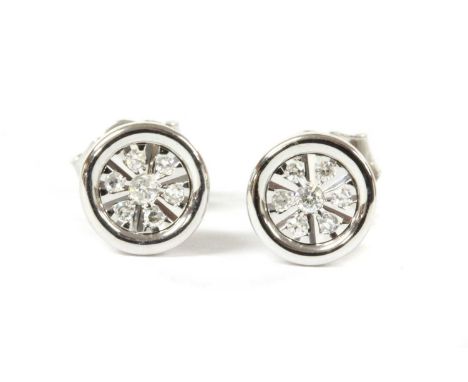 A pair of white gold diamond earrings, brilliant cut diamonds, grain set to the circular stud, with post and scroll fittings,