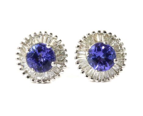 A pair of white gold tanzanite and diamond cluster stud earrings, a circular mixed cut diamond, 4.5mm, claw set to surround o