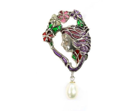 An Art Nouveau style plique-à-jour enamel brooch, depicting a female in profile facing left, with pink and purple enamel hair