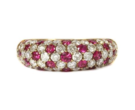 A gold ruby and diamond ring, the slightly tapered bombé form head pavé set with brilliant cut diamonds and circular mixed cu
