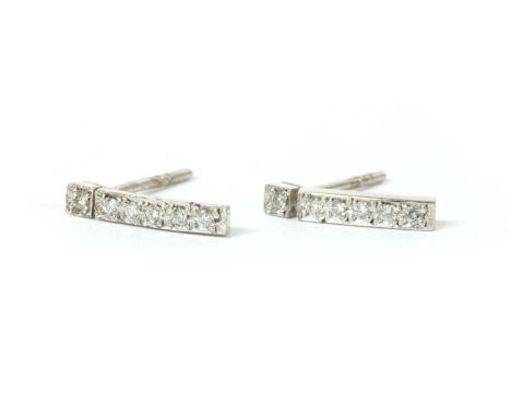 A pair of 18ct white gold diamond set bar earrings, a row of brilliant cut diamonds, grain set, to post fittings, butterflies