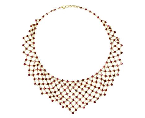 A gold ruby bib-style necklace, with a series of round mixed cut rubies, all spectacle set and joined by jump rings, to a hoo