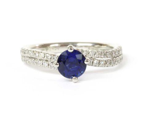 A platinum single stone sapphire crossover ring, with two row diamond set shoulders, 4.54g.Finger size KCondition report: Und