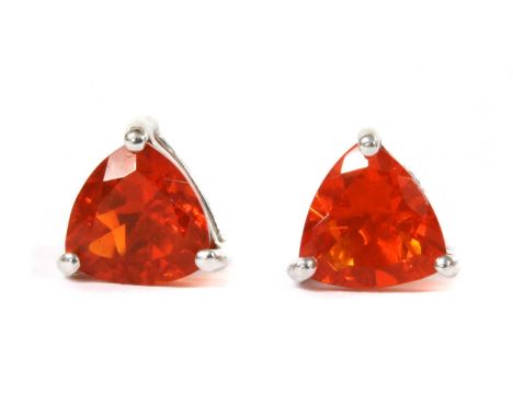 A pair of white gold single stone fire opal stud earrings, a triangular mixed cut fire opal, approximately 6.5mm, claw set to