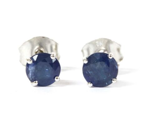 A pair of white gold single stone sapphire stud earrings, a circular mixed cut sapphire, approximately 5mm, claw set to post 