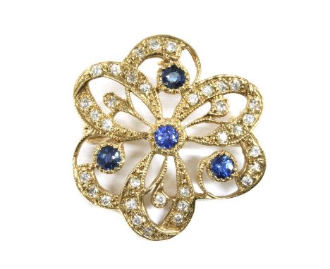 A 9ct gold sapphire and diamond brooch, of openwork floral design, with circular mixed cut sapphires grain set to plain colle