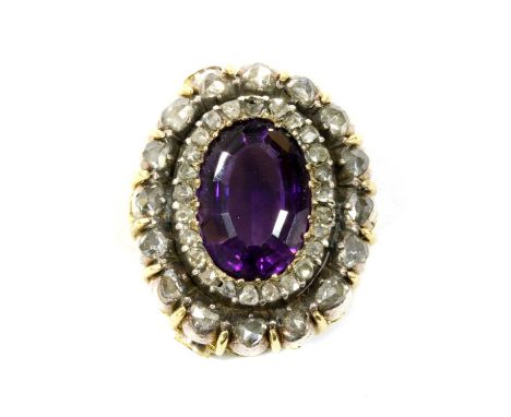 A Victorian amethyst and diamond oval cluster head, later mounted as a centrepiece or pendant, with an oval step cut amethyst