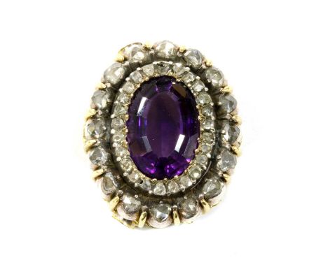 A Victorian amethyst and diamond oval cluster head, later mounted as a centrepiece or pendant, with an oval step cut amethyst