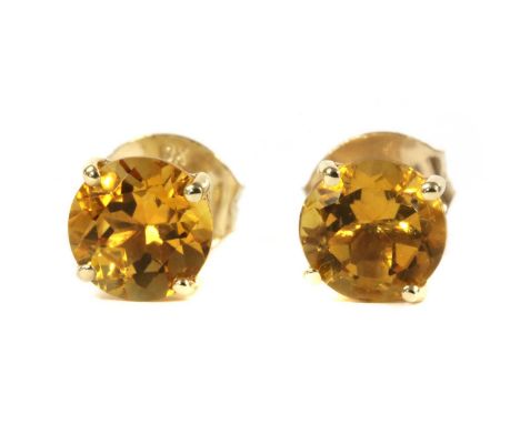 A pair of gold single stone citrine stud earrings, a circular mixed cut citrine, approximately 6mm, claw set to post and butt