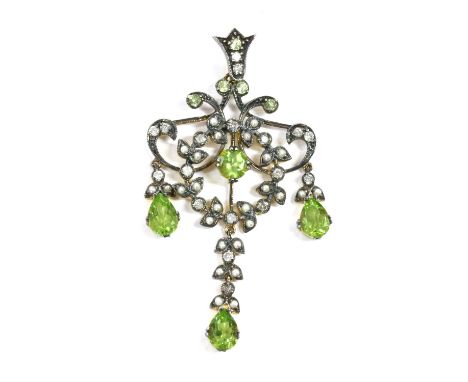 A silver and gold, peridot, split pearl and diamond pendant, a circular mixed cut peridot, claw set, to wreath grain set with