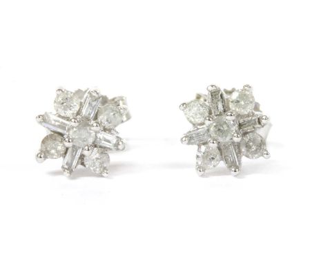 A pair of white gold diamond cluster earrings, a brilliant cut diamond, with surround of alternating brilliant cut and baguet