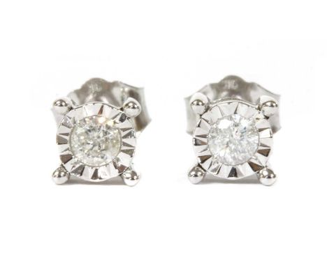 A pair of white gold single stone diamond stud earrings, a brilliant cut diamond grain set to an illusion collet, to post and