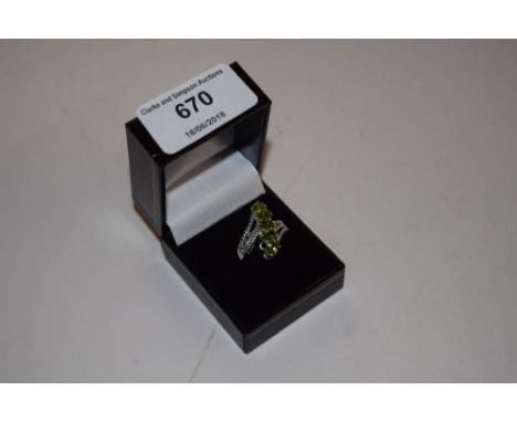 A peridot five stone and silver ring 