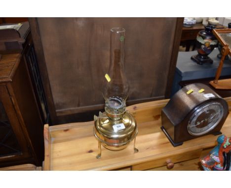 A brass oil lamp with glass chiminea