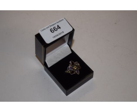 A silver ring set with garnet, peridot, topaz etc. 