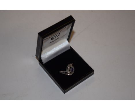 A silver white and purple stone set ring 