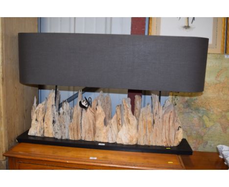 A large driftwood lamp and shade 